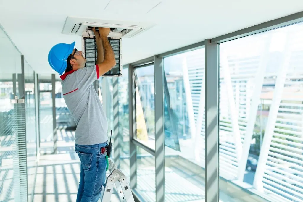 Alpha TAB technician testing a ceiling unit on a commercial project in Anne Arundel County